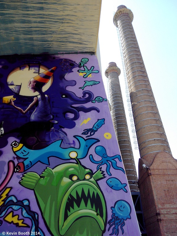 The three chimneys are from the power plant known as La Canadenca (The Canadian), despite the fact that its founder, Pearson, was born in Massachusetts and its capital was Belgian