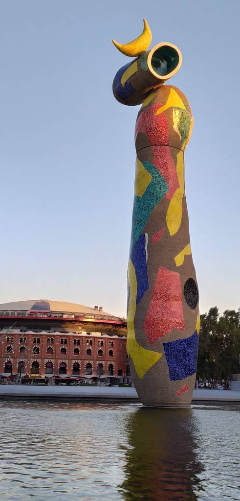 Miró's Woman and Bird on a summer's evening, showing the Arenas complex in the background